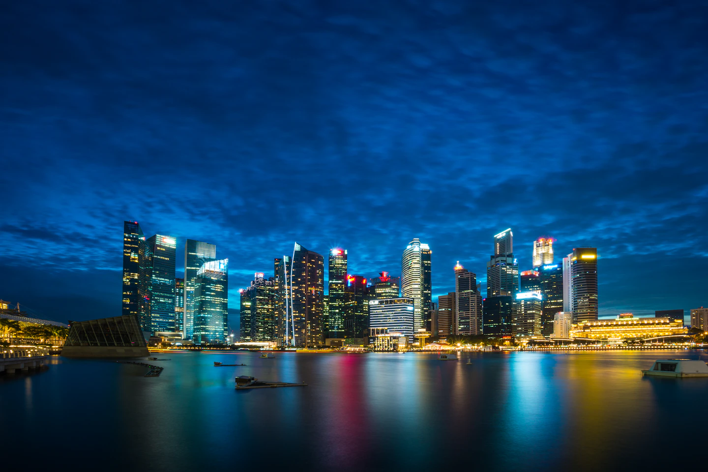 Singapore’s business district across Marina Bay at dusk